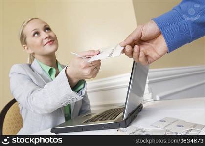 Receptionist distributing name tags