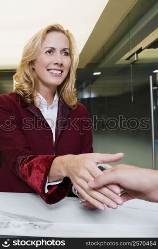 Receptionist giving the cardkey to a customer