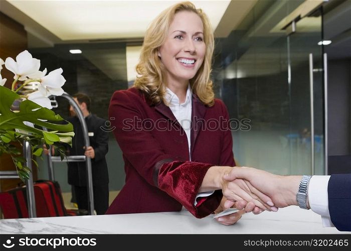 Receptionist giving the cardkey to a customer