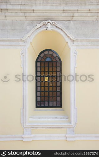 Recessed window with colored panes in building in Lisbon, Portugal.