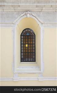 Recessed window with colored panes in building in Lisbon, Portugal.