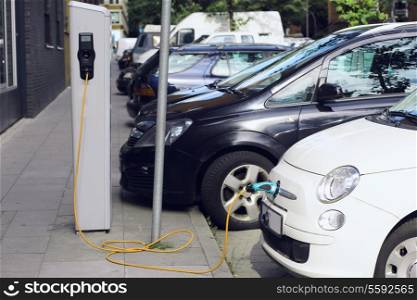 Recharge. Electric Car in Free Charging Station. Environmentally Friendly Transport