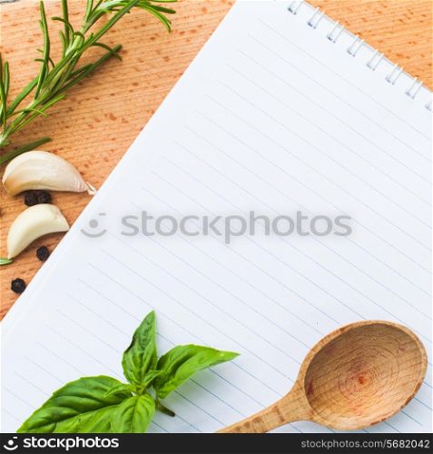 Recipe concept. Blank sheet of paper on a wooden board with spices