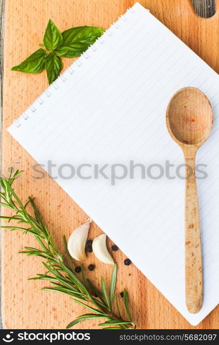 Recipe concept. Blank sheet of paper on a wooden board with spices