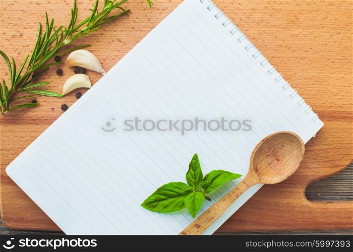Recipe concept. Blank sheet of paper on a wooden board with spices. The recipe concept