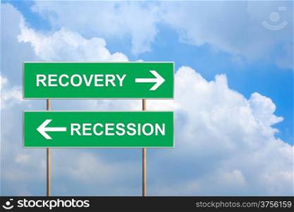 recovery and recession on green road sign with blue sky