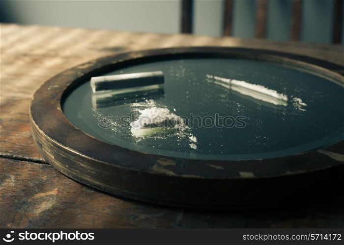 Recreational drugs and banknote on a mirror