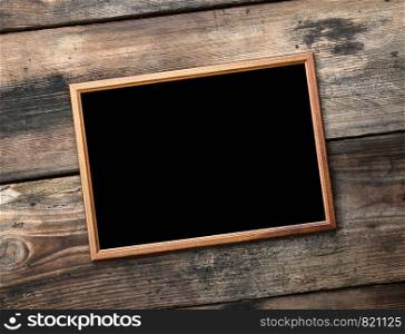 rectangular brown wooden frame on a background of very old boards, empty space