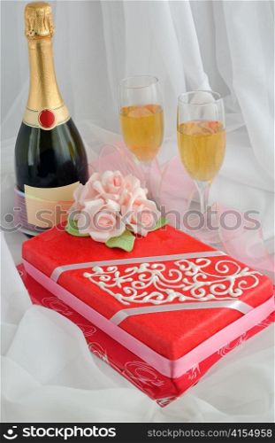 Rectangular cake with marzipan roses and champagne by the glass