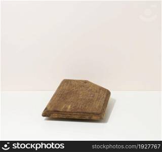 rectangular empty brown wooden kitchen board on a white table, utensils. Place to display food