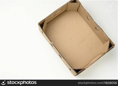 rectangular empty cardboard box of brown paper on a white background, box without a lid for vegetables and fruits in with holes, top view
