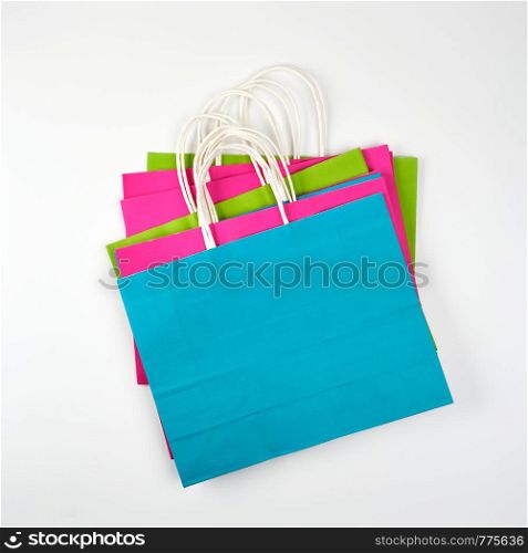 rectangular multi-colored paper shopping bags with handles on a white background, flat lay