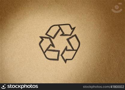 ""Recyclable" universal symbol, printed on brown cardboard"
