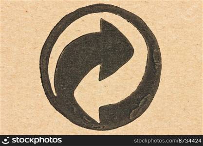 recycle arrows printed on a recycled cardboard