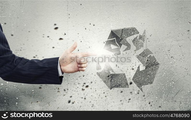 Recycle concept. Businessman breaking recycle stone symbol with finger