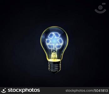 Recycle concept. Glowing lightbulb with recycle symbol inside on dark background
