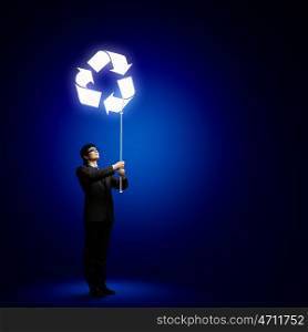 Recycle concept. Image of businessman holding balloon. Ecology idea