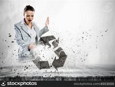 Recycle concept. Image of businesswoman crashing recycle stone symbol