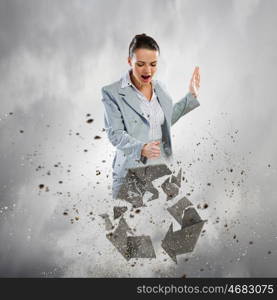 Recycle concept. Image of businesswoman crashing recycle stone symbol