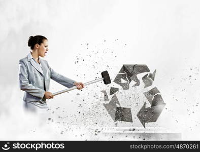 Recycle concept. Image of businesswoman crashing recycle stone symbol