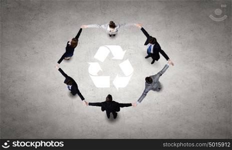 Recycle concept. Top view of business team making recycling figure