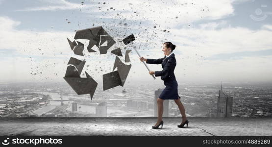 Recycle concept. Young businesswoman in anger crashing stone recycle symbol