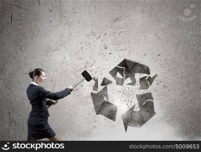 Recycle concept. Young businesswoman in anger crashing stone recycle symbol