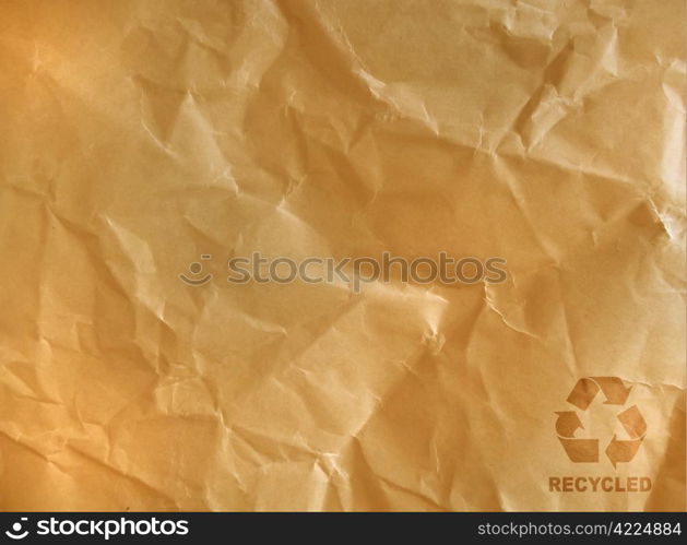 recycle sign on brown crumpled paper.