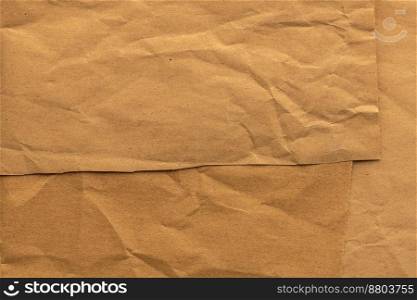 Recycled beige creased paper background or cardboard surface from a paper box for packing. For the designs decoration concept