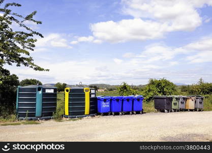 Recycling bin for bottles and jars, plastic and paper on the edge of the road in the French department of Gard.