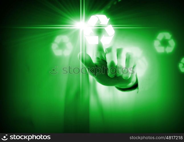 Recycling concept. Close up of businessman touching green recycle icon