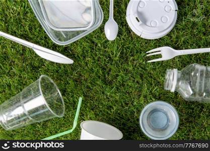 recycling, environment and ecology concept - close up of plastic waste on grass. close up of plastic waste on grass