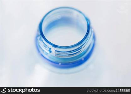 recycling, healthy eating and food storage concept - close up of clean empty used plastic water bottle neck