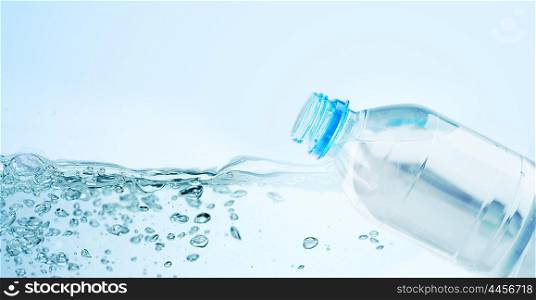 recycling, healthy eating and food storage concept - close up of plastic bottle with pure drinking water over blue background