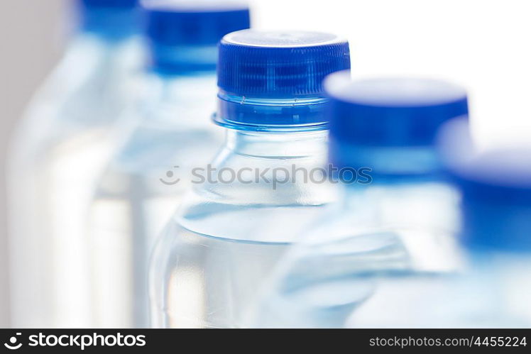 recycling, healthy eating, industry, packing and food storage concept - close up of plastic bottles with pure drinking water