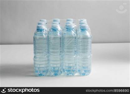 recycling, packing and storage concept - close up of plastic bottles with pure drinking water on table. close up of plastic bottles with drinking water