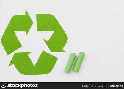 recycling symbol beside green batteries. High resolution photo. recycling symbol beside green batteries. High quality photo