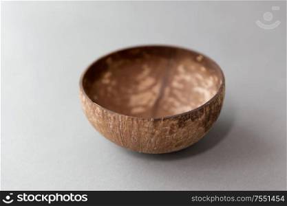 recycling, tableware and eco friendly concept - close up of coconut bowl on table. close up of coconut bowl on table