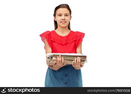 recycling, waste sorting and sustainability concept - smiling girl holding heap of paper magazines over white background. smiling girl with magazines sorting paper waste