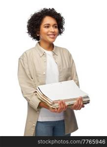 recycling, waste sorting and sustainability concept - smiling woman holding heap of paper magazines over white background. smiling woman with magazines sorting paper waste