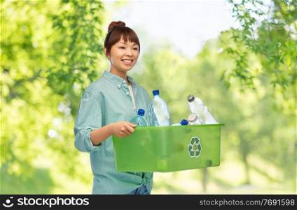 recycling, waste sorting and sustainability concept - smiling young asian woman holding box with plastic bottles over green natural background. smiling young asian woman sorting plastic waste