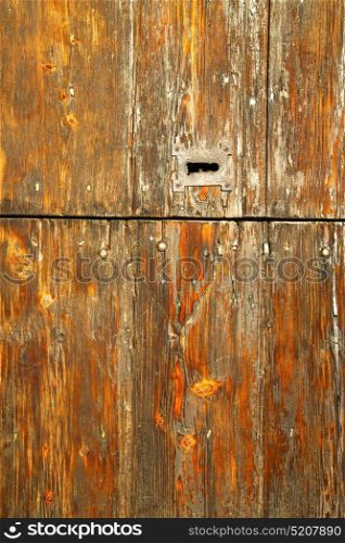 red abstract house door in italy lombardy column the milano old closed nail rusty