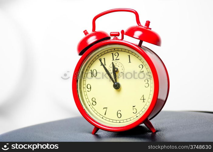 red alarm clock in a retro style shot in a studio