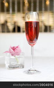 red alcohol cocktail in glass with orchid