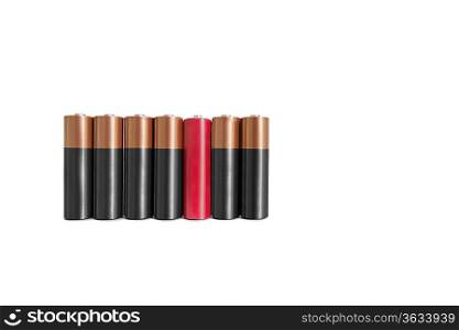 Red amid black batteries over white background