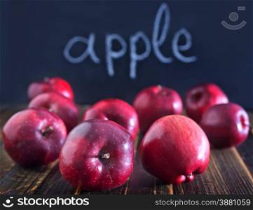 red and big apples on the wooden table