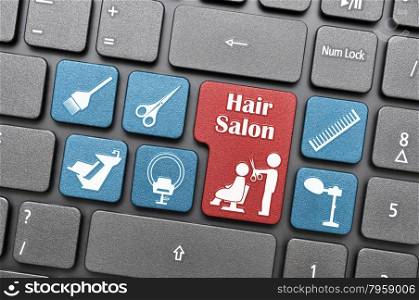Red and blue hair salon key on keyboard