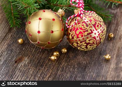 red and golden christmas balls on wooden table background. red and golden christmas balls