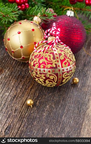 red and golden christmas balls . red and golden christmas balls on wooden table