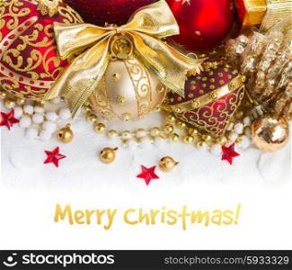 red and golden christmas decorations in snow border on white background. golden christmas decorations
